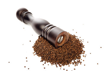 pepper mill on peppercorns heap, isolated on white