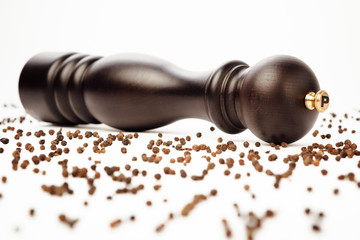 pepper mill and peppercorns, isolated on white
