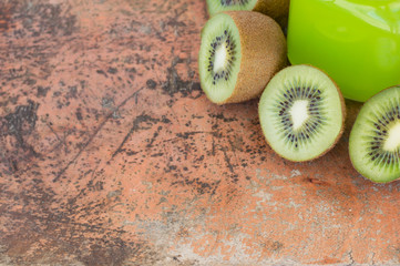 Background with kiwi fruits on a wooden table with scratches