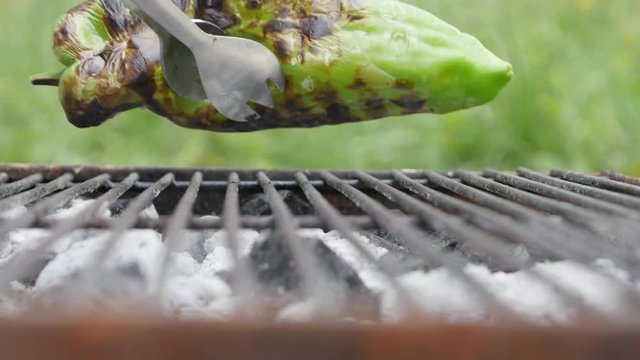 Taking green organic pepper grilled on bbq close-up 4K 3840X2160 UltraHD footage - Capiscum annuum vegetable on barbecue smoked on fire 4K 2160p UHD video 
