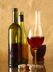 wine bottle and wine glass on a glass table