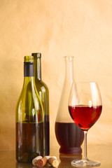 wine bottle and wine glass on a glass table