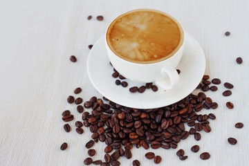 Coffee cup and beans, white background. still life on table cloths