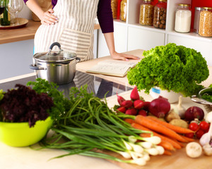 Young Woman Cooking in the kitchen. Healthy Food