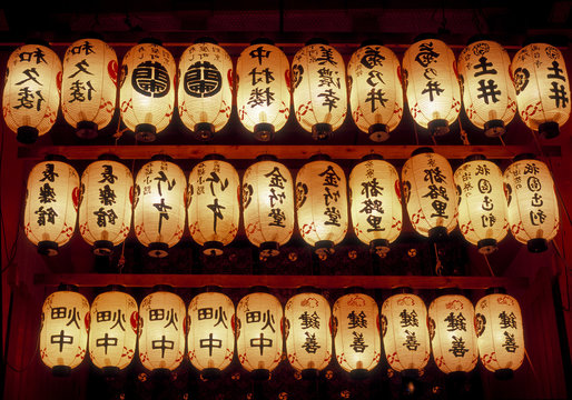 Rows of illuminated prayer lanterns at night
