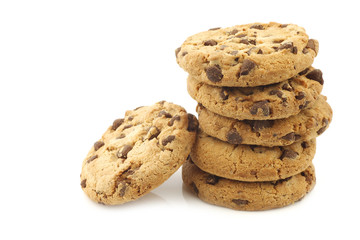 stacked crunchy chocolate chip cookies on a white background
