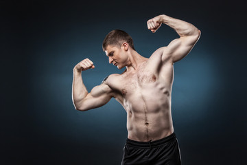 Sporty and healthy man isolated on dark blue background