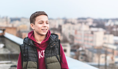 happy teenager on the roof of the house