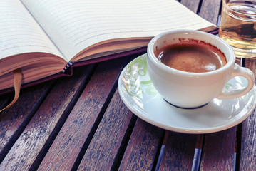 Coffee cup on wooden table - Vintage effect style pictures, over light [blur and select focus background] 