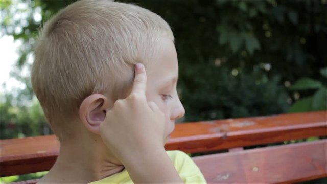 child picking his nose/funny boy picking his nose and showing emotions