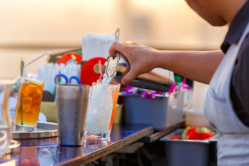 Obraz na płótnie Canvas Process of preparing a cocktail bartender's from passion fruits