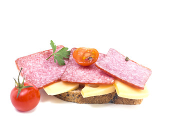 delicious sandwich of cold cuts of hard cheese and a tomato