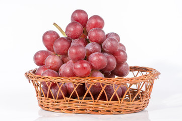grapes in a basket isolated on white background