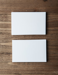 Photo of two blank stack business cards. Empty cardS on wood table background, ready for your private information. Vertical mockup    