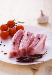 Pork sparerib raw with spices on plate
