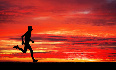 Running man on apocalyptic sunset sky background