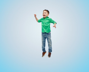 Obraz premium happy little boy jumping in air