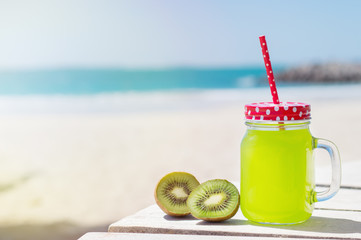 Fresh juice and kiwi slices at the sunny beach