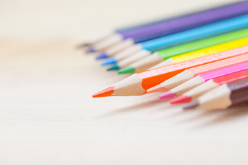 color pencil with sharpener on wood background, colorful kids school artist concept.