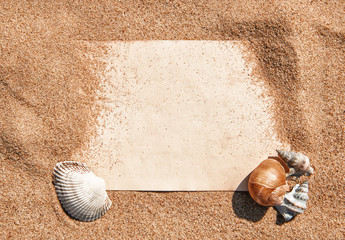 Summer background with paper and seashells on the sand