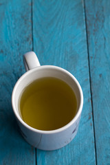 Green tea on blue wooden background