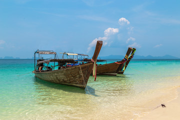 Fototapeta premium Fisherman wooden boat on sea coast with turquoise water