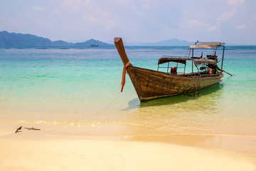 Fototapeta na wymiar Fisherman wooden boat on sea coast with turquoise water