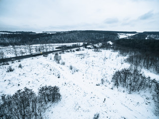 aerial view on a snowy field and road from quadrocopter