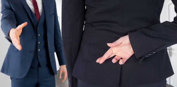 Composite image of businesswoman with fingers crossed - Powered by Adobe