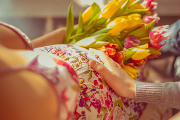 Pregnant in the pink dress with tulips
