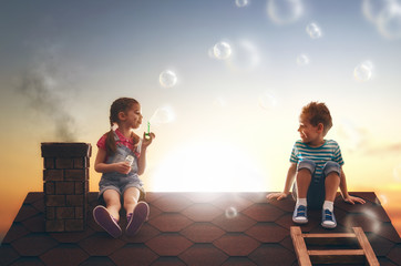 child blowing soap bubbles