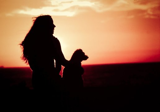 silhouette of lady with her dog