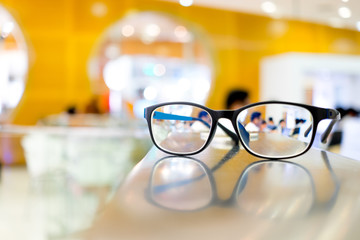 Fototapeta na wymiar Eye glasses on table in library