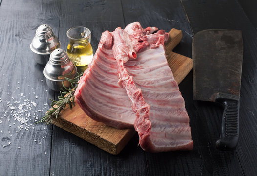 Raw pork ribs with spices, salt and rosemary