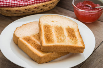Toasts on plate and strawberry jam