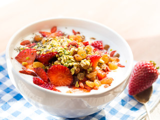 Smoothie bowl with strawberries, dried fruit and chia seeds