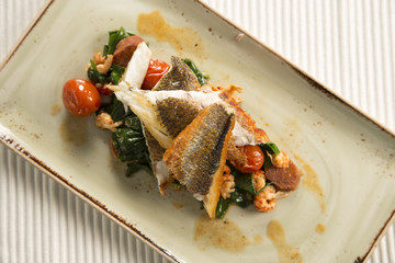 Pan fried sea bass with crayfish, chorizo, baby spinach & cherry tomatoes 
