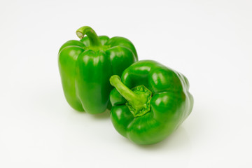 Obraz na płótnie Canvas Two green bell peppers, on white background.