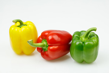 Three colorful bell peppers, on white background.