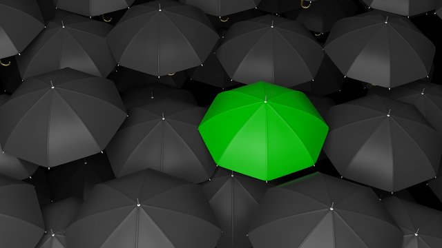 3D rendering of classic large black umbrellas tops with one green standing out.
