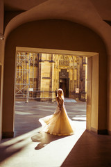 Fairytale beautiful blonde bride dancing under archway hall at s