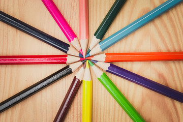 color pencils on wood table background vintage color tone, artist school concept.