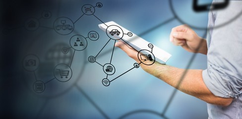 Composite image of businessman using digital tablet 