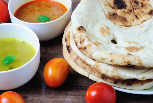 Nepalese/Indian Naan Flatbread with curry and dhal sauce, a plain Indian roti also know as  plain tandoori roti.