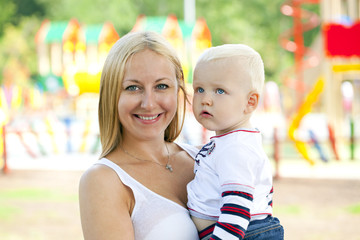 Young mother holds on hands of his two year old son