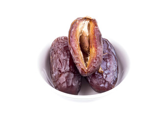 sweet dry date palm fruit on white dish