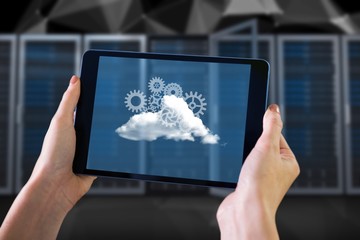 Composite image of finger pointing to tablet