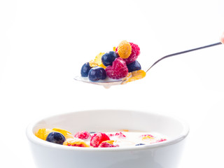 ripe raspberry and blueberry and milk on the white dish