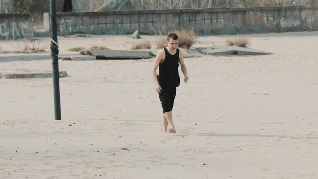 man jumping dangerous stunt on the beach