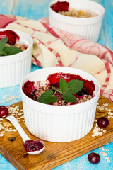 Homemade cherry crumble on a blue wooden background